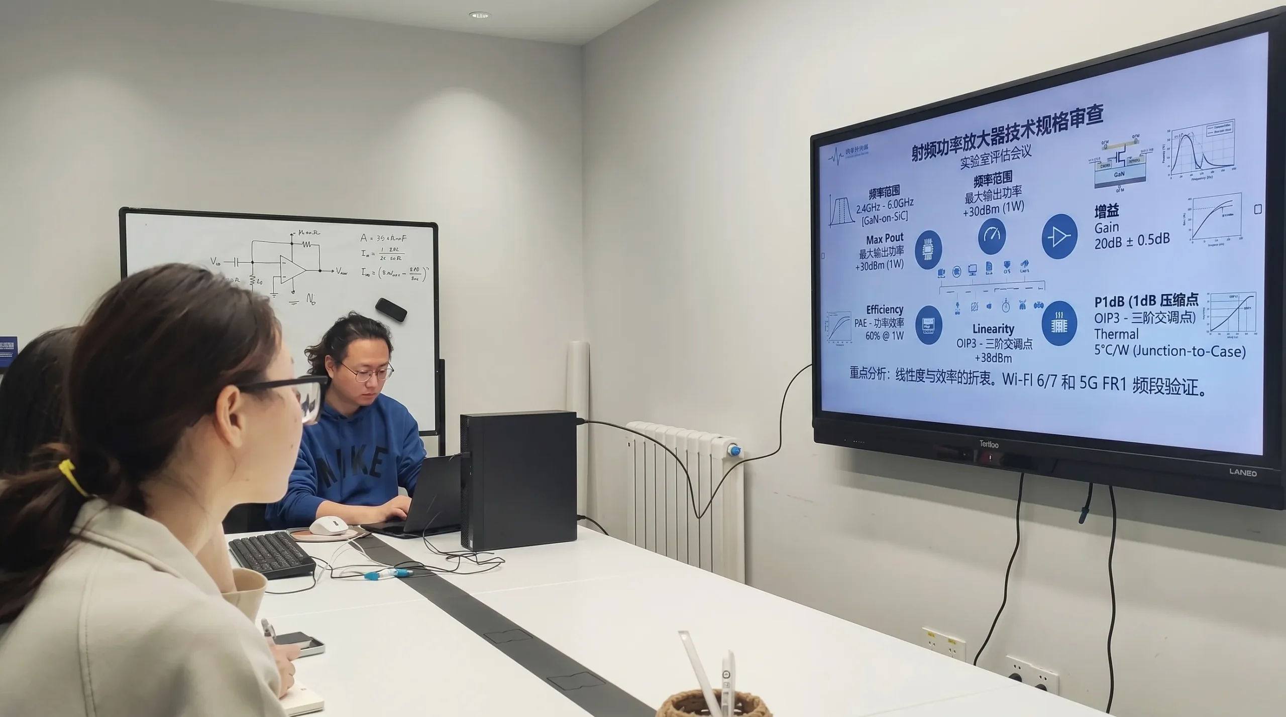 Engineers discussing technical specifications in a lab meeting