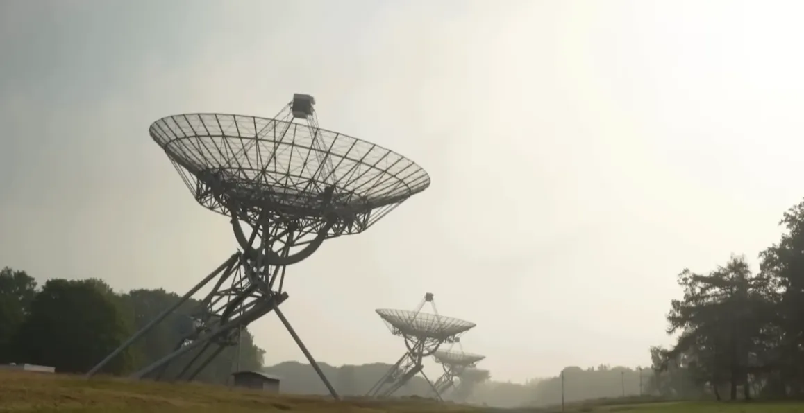 A satellite dish pointing to the sky, illustrating a SATCOM link