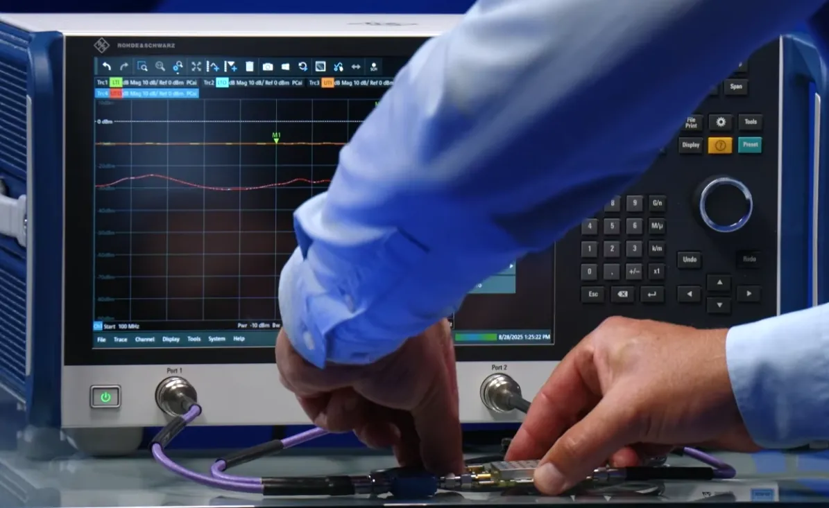 An RF engineer adding an attenuator to a test setup